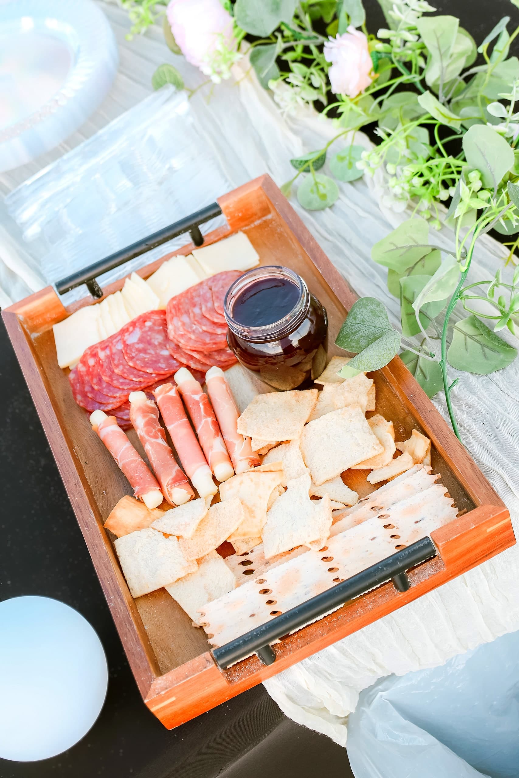 A curated charcuterie and grazing board with florals
